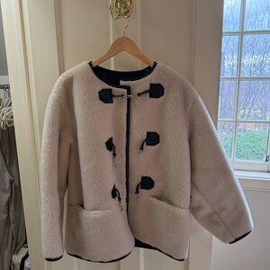 We Are faux shearling jacket. 30% wool and 70% poly. Very warm.